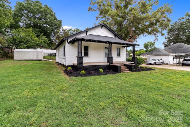 1406 Upper Enochville Rd, Kannapolis, NC 28081 - view of front of home featuring covered porch, a front lawn, roof with shingles, and driveway