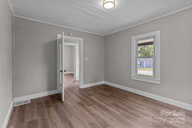 1406 Upper Enochville Rd, Kannapolis, NC 28081 - empty room featuring crown molding, wood finished floors, and baseboards