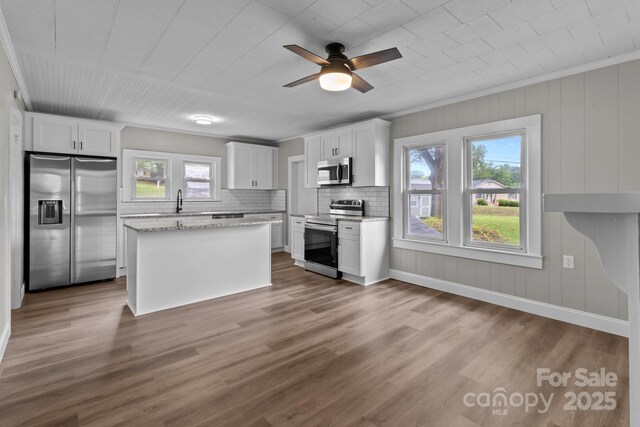 1406 Upper Enochville Rd, Kannapolis, NC 28081 - kitchen featuring appliances with stainless steel finishes, tasteful backsplash, white cabinets, a ceiling fan, and crown molding