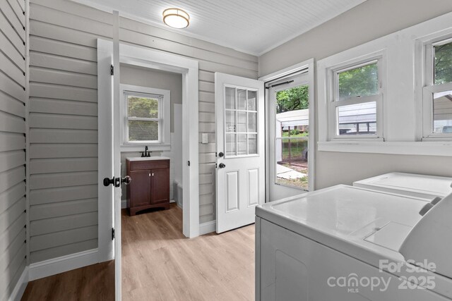 1406 Upper Enochville Rd, Kannapolis, NC 28081 - laundry area with washing machine and dryer, light wood-style flooring, plenty of natural light, and baseboards