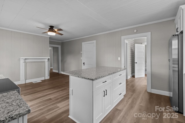 1406 Upper Enochville Rd, Kannapolis, NC 28081 - kitchen featuring freestanding refrigerator, ceiling fan, white cabinetry, ornamental molding, and baseboards