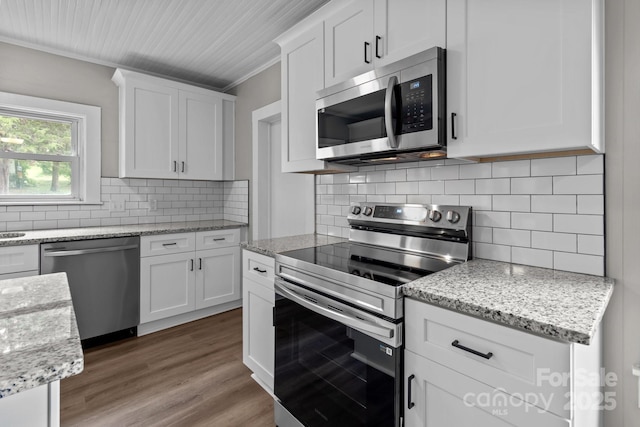 1406 Upper Enochville Rd, Kannapolis, NC 28081 - kitchen with appliances with stainless steel finishes, ornamental molding, white cabinetry, light wood-style floors, and backsplash