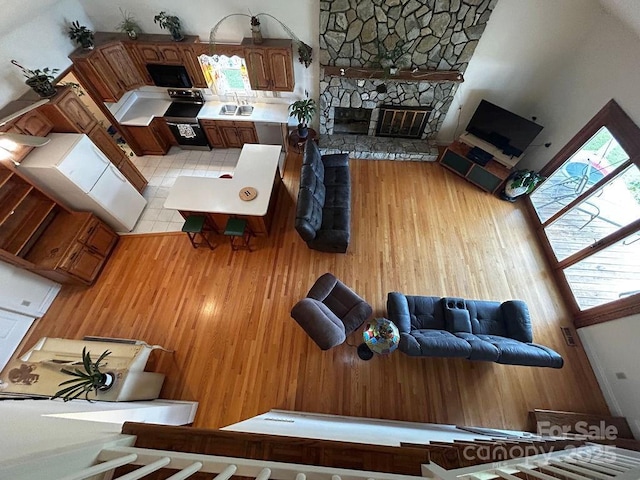 4574 Ivy Run Ln, Denver, NC 28037 - living room featuring a stone fireplace and wood finished floors
