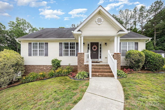 426 Carriage Ln, Linwood, NC 27299 - view of front of home featuring a front yard, covered porch, and roof with shingles