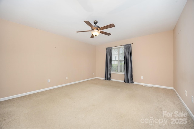 426 Carriage Ln, Linwood, NC 27299 - unfurnished room with light carpet, baseboards, and a ceiling fan