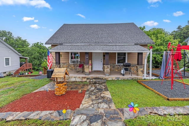 61 First St, Marion, NC 28752 - bungalow featuring a shingled roof, a front lawn, a playground, stone siding, and covered porch