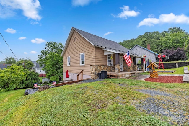 61 First St, Marion, NC 28752 - view of front of home featuring a front lawn, stone siding, and covered porch