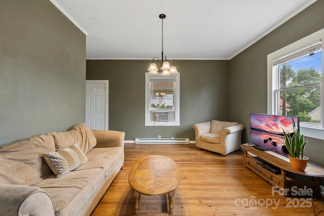 61 First St, Marion, NC 28752 - living area featuring ornamental molding, light wood-type flooring, a baseboard radiator, and a chandelier