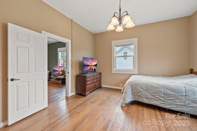 61 First St, Marion, NC 28752 - bedroom with a chandelier, light wood-style floors, and baseboards