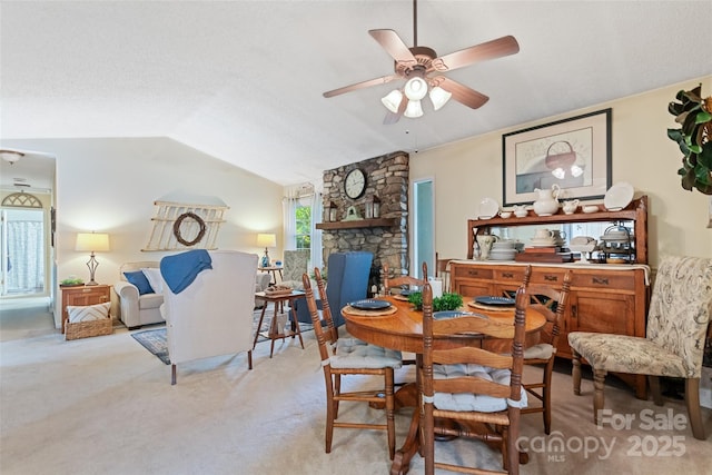 16 Fieldstone Ct, Arden, NC 28704 - dining area featuring carpet, vaulted ceiling, a ceiling fan, and a stone fireplace