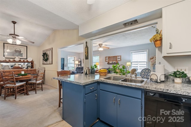 16 Fieldstone Ct, Arden, NC 28704 - kitchen with dishwasher, a ceiling fan, blue cabinets, a peninsula, and lofted ceiling