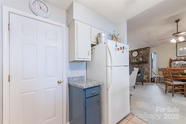 16 Fieldstone Ct, Arden, NC 28704 - kitchen with freestanding refrigerator, light colored carpet, a ceiling fan, light countertops, and white cabinets