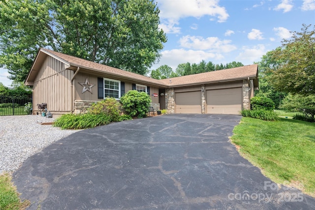16 Fieldstone Ct, Arden, NC 28704 - single story home with stone siding, driveway, an attached garage, and board and batten siding