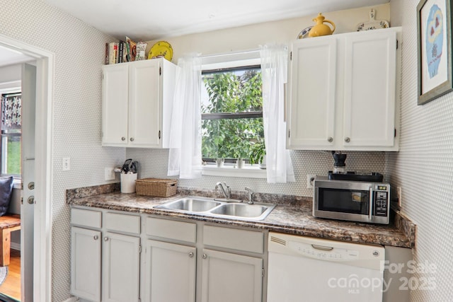 615 Biltmore Ave Unit K2, Asheville, NC 28803 - kitchen featuring stainless steel microwave, white dishwasher, a sink, white cabinetry, and dark countertops