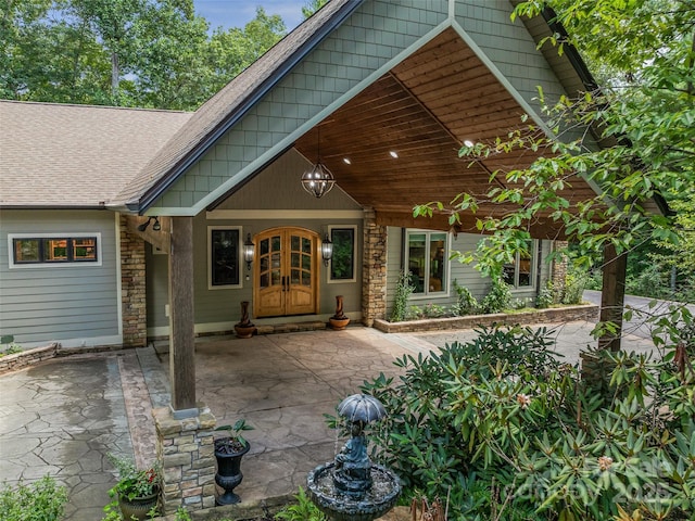 105 Blackberry Ln, Fairview, NC 28730 - property entrance with a shingled roof, stone siding, and french doors
