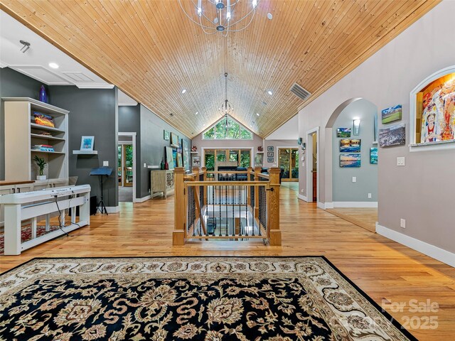 105 Blackberry Ln, Fairview, NC 28730 - living area featuring wood finished floors, wood ceiling, arched walkways, baseboards, and lofted ceiling