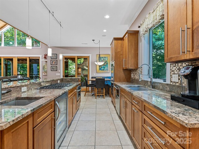 105 Blackberry Ln, Fairview, NC 28730 - kitchen featuring a sink, brown cabinetry, stainless steel gas stovetop, and recessed lighting