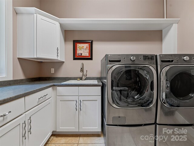105 Blackberry Ln, Fairview, NC 28730 - laundry area featuring washer and clothes dryer, cabinet space, and light tile patterned floors