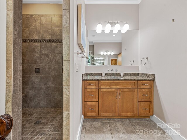 105 Blackberry Ln, Fairview, NC 28730 - bathroom featuring crown molding, tiled shower, vanity, and baseboards