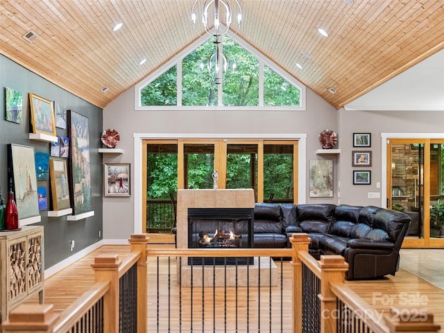 105 Blackberry Ln, Fairview, NC 28730 - tiled living area with high vaulted ceiling, a chandelier, and a tiled fireplace