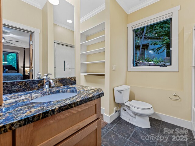 105 Blackberry Ln, Fairview, NC 28730 - ensuite bathroom featuring crown molding, baseboards, vanity, and toilet