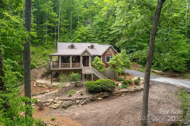 45 Boulder Creek Ln Unit 28, Tuckasegee, NC 28783 - chalet / cabin with stairway, covered porch, a forest view, and driveway
