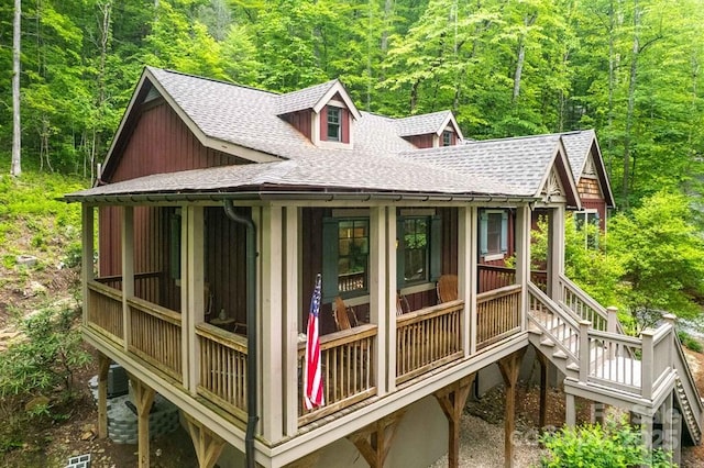 45 Boulder Creek Ln Unit 28, Tuckasegee, NC 28783 - view of property exterior with roof with shingles, a view of trees, and stairs