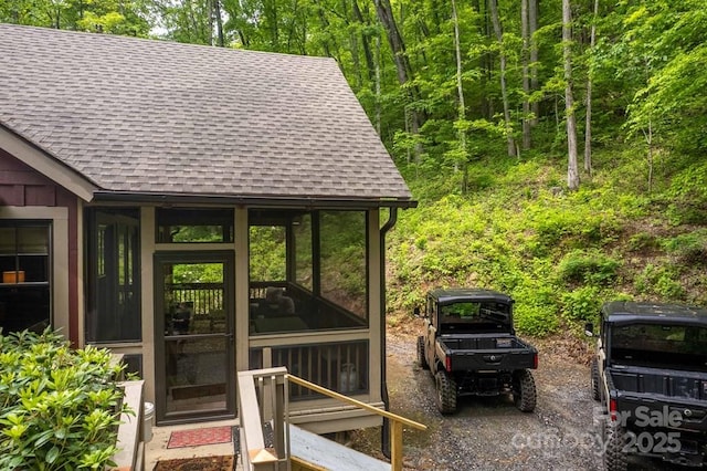 45 Boulder Creek Ln Unit 28, Tuckasegee, NC 28783 - view of outdoor structure featuring a sunroom and a wooded view