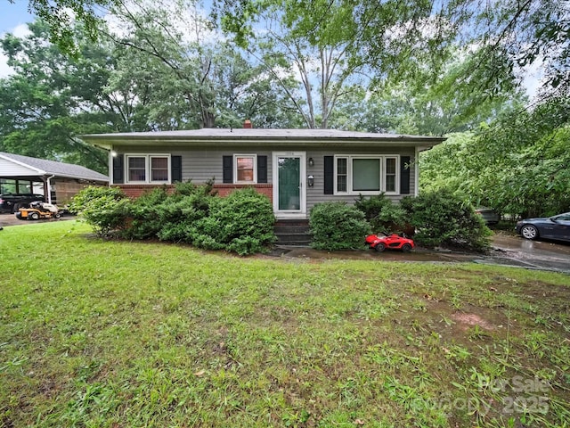 1004 E 8th Ave, Gastonia, NC 28054 - view of front facade featuring a front yard, brick siding, and entry steps