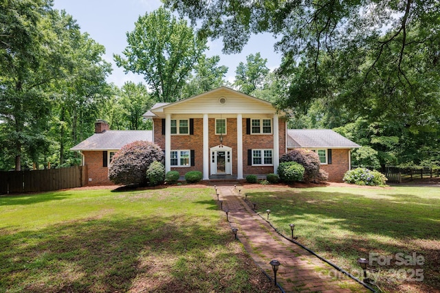 2605 Camelot Dr, Rock Hill, SC 29732 - neoclassical / greek revival house featuring brick siding, a chimney, and view of wooded area