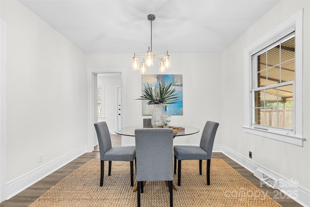 3726 The Plz, Charlotte, NC 28205 - dining room featuring dark wood-style flooring, a chandelier, and baseboards