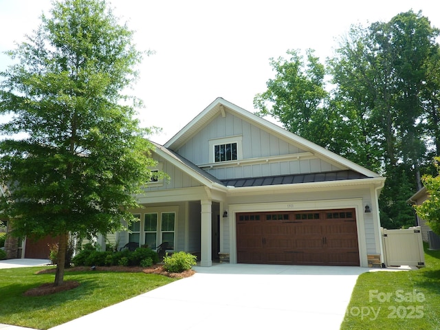 1311 Stonecroft Ln NW, Concord, NC 28027 - craftsman house featuring board and batten siding, driveway, a front lawn, an attached garage, and a standing seam roof