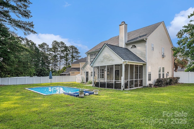 203 Alyssum Ct, Myrtle Beach, SC 29579 - rear view of property featuring a sunroom, a chimney, and roof with shingles