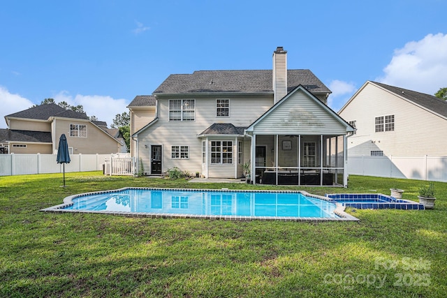 203 Alyssum Ct, Myrtle Beach, SC 29579 - back of house featuring a sunroom, a chimney, and a pool with connected hot tub