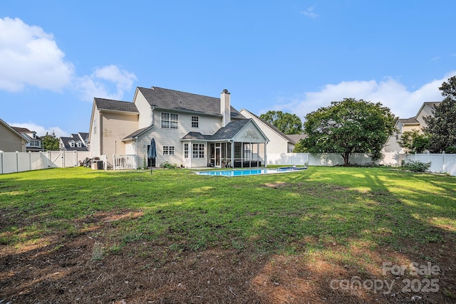 203 Alyssum Ct, Myrtle Beach, SC 29579 - rear view of property with a sunroom and a chimney