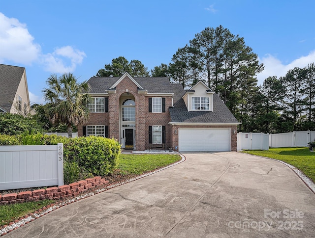 203 Alyssum Ct, Myrtle Beach, SC 29579 - colonial inspired home featuring a gate, brick siding, concrete driveway, a garage, and a shingled roof