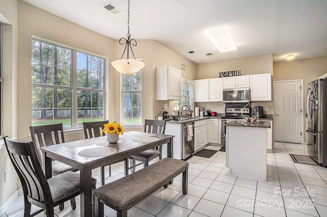 203 Alyssum Ct, Myrtle Beach, SC 29579 - kitchen with stainless steel appliances, a kitchen island, white cabinets, a textured ceiling, and a sink