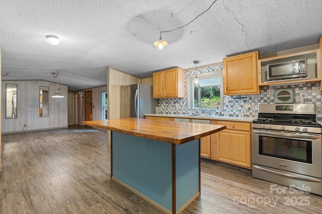 2951 Evergreen Trl, Vale, NC 28168 - kitchen with appliances with stainless steel finishes, wood counters, vaulted ceiling, wood finished floors, and tasteful backsplash