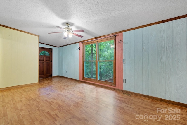 2951 Evergreen Trl, Vale, NC 28168 - spare room featuring wood finished floors, a ceiling fan, ornamental molding, a textured ceiling, and baseboards