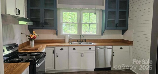 804 N Main St, Oakboro, NC 28129 - kitchen featuring butcher block counters, stainless steel appliances, a sink, and under cabinet range hood