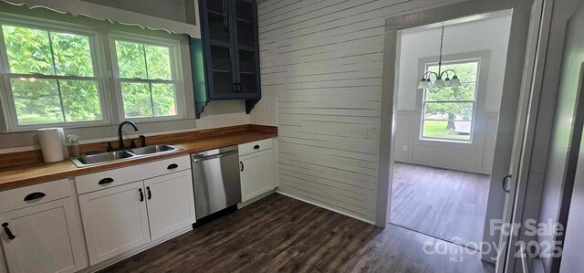 804 N Main St, Oakboro, NC 28129 - kitchen featuring dishwasher, butcher block counters, a sink, wooden walls, and dark wood-type flooring