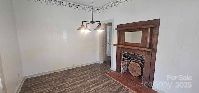 804 N Main St, Oakboro, NC 28129 - unfurnished living room with dark wood finished floors, a chandelier, baseboards, and a fireplace with raised hearth