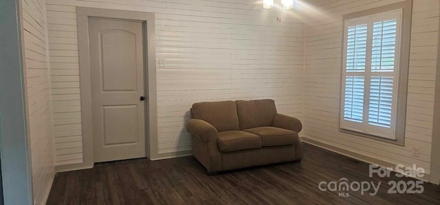 804 N Main St, Oakboro, NC 28129 - sitting room featuring dark wood-type flooring, healthy amount of natural light, and wooden walls