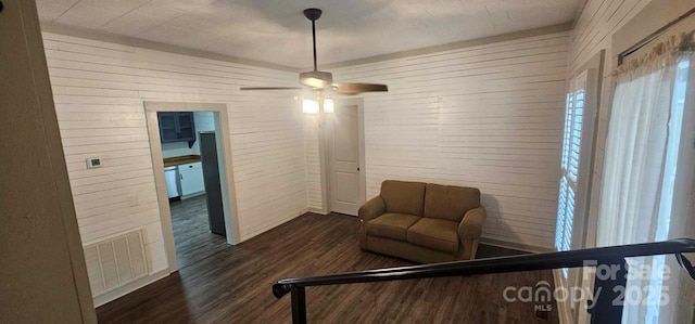 804 N Main St, Oakboro, NC 28129 - bedroom with dark wood finished floors, ceiling fan, and wooden walls