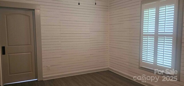 804 N Main St, Oakboro, NC 28129 - unfurnished room with dark wood-type flooring and baseboards
