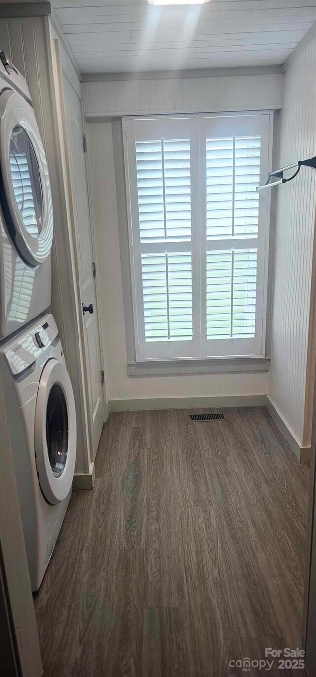 804 N Main St, Oakboro, NC 28129 - laundry area featuring stacked washing machine and dryer, wood finished floors, and baseboards