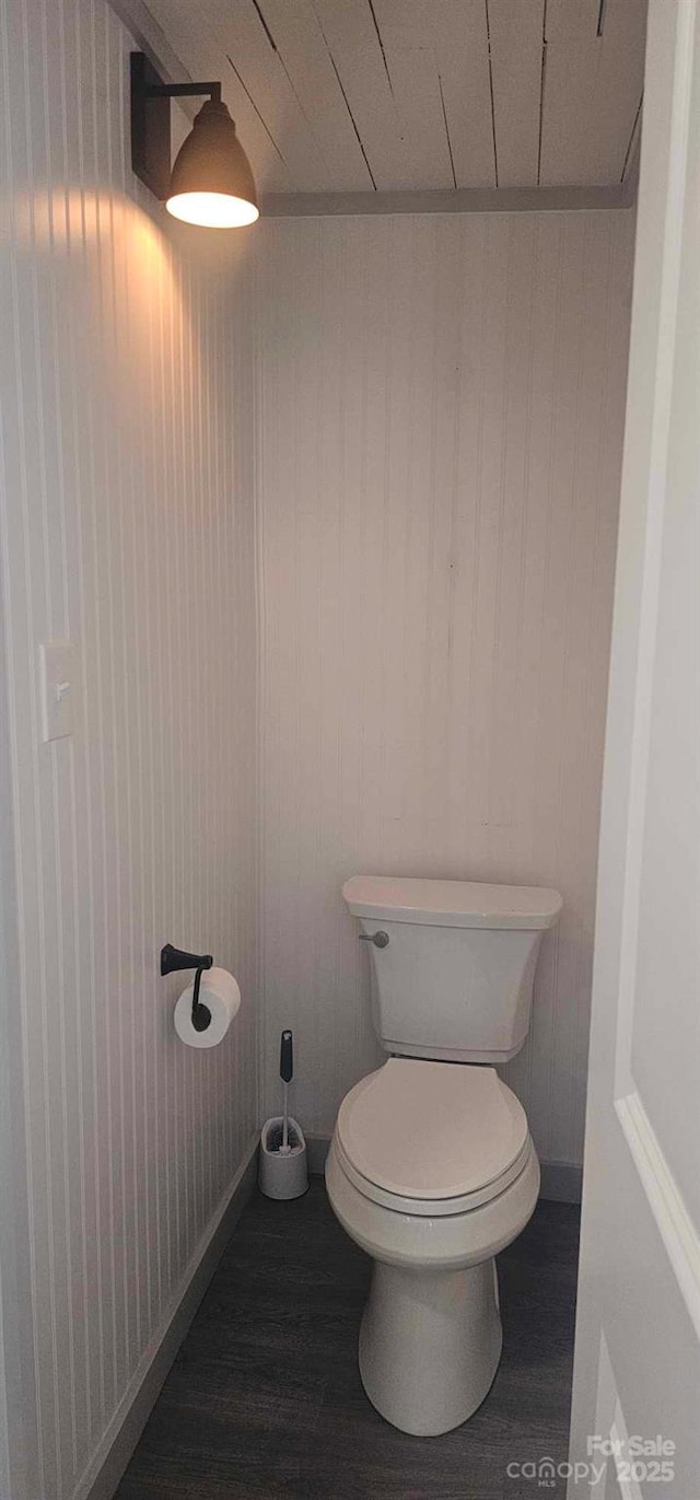 804 N Main St, Oakboro, NC 28129 - bathroom featuring toilet, wood finished floors, wallpapered walls, and baseboards