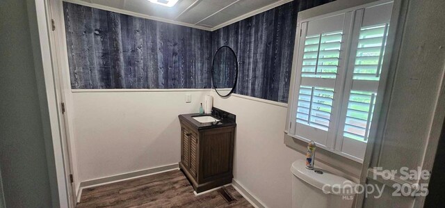 804 N Main St, Oakboro, NC 28129 - bathroom featuring vanity, wood finished floors, toilet, and crown molding