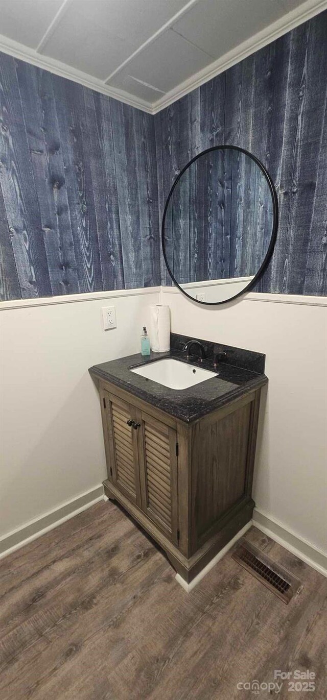 804 N Main St, Oakboro, NC 28129 - bathroom featuring vanity, wood finished floors, baseboards, and crown molding