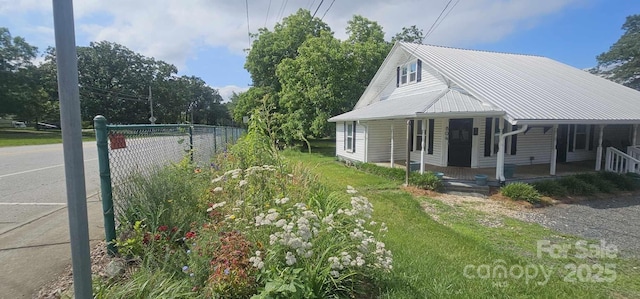 804 N Main St, Oakboro, NC 28129 - view of side of home with covered porch and metal roof